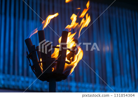 Burning torches in front of traditional buildings in Okinawa, Japan 131854304