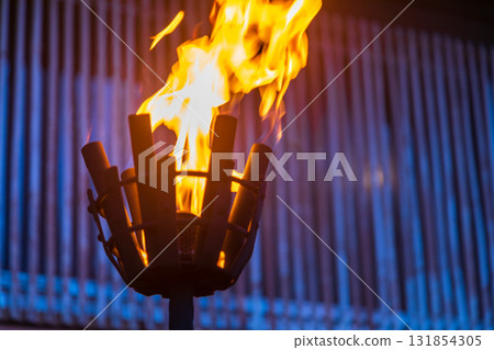 Burning torches in front of traditional buildings in Okinawa, Japan 131854305