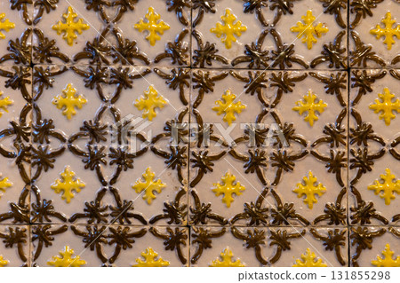 Intricate Yellow and Brown Ceramic Tile Pattern with Star Motifs Intricate Yellow and Brown Ceramic Tile Pattern with Star Motifs 131855298