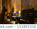 Vibrant Stained Glass Light on Cathedral Wooden Pew at Dusk 131855316
