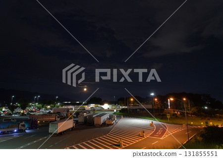 A highway parking lot and service area illuminated by the full moon 131855551