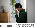 Distressed woman holding head nearly crying alone in emotional struggle at home, female fatigue 131855585