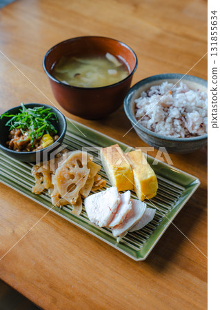 Japanese-style breakfast of tamagoyaki (rolled omelet), chicken breast, lotus root stir-fry, and miso soup Japanese-style breakfast of tamagoyaki (rolled omelet), chicken breast, lotus root stir-fry, and miso soup 131855634