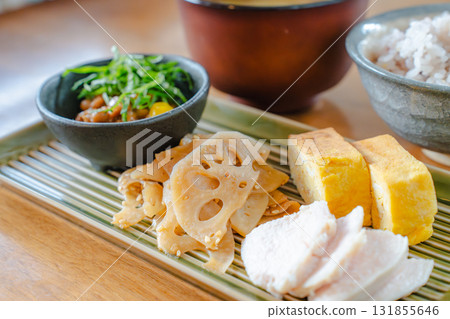 Japanese-style breakfast of tamagoyaki (rolled omelet), chicken breast, lotus root stir-fry, and miso soup 131855646