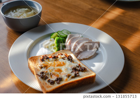A healthy breakfast of cheese toast, chicken breast, vegetables and soup A healthy breakfast of cheese toast, chicken breast, vegetables and soup 131855713