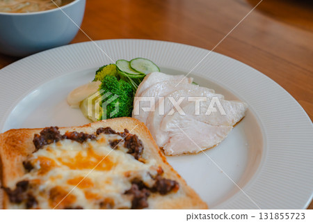 A healthy breakfast of cheese toast, chicken breast, vegetables and soup 131855723