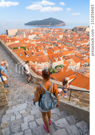 Woman exploring Dubrovnik Old Town enjoying city view and Adriatic Sea 131856665