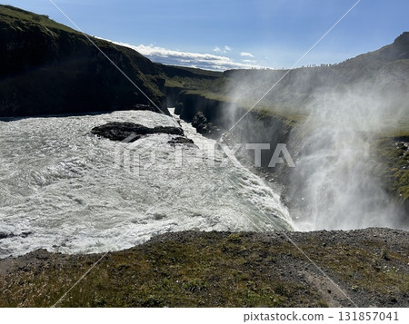 This is a view of the huge waterfall, Gullfoss, in Iceland, and the spray of water from the side. 131857041