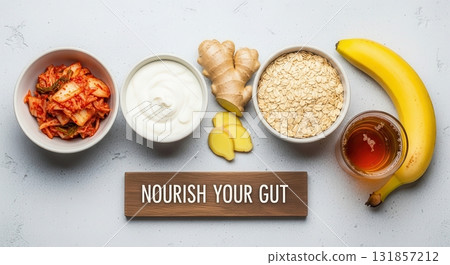 Nourish your gut, top view of probiotic and prebiotic foods like kimchi, yogurt, oats, banana 131857212
