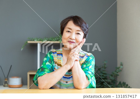 Senior woman smiling with a relaxed expression, hands on cheeks, upper body Senior woman smiling with a relaxed expression, hands on cheeks, upper body 131857417