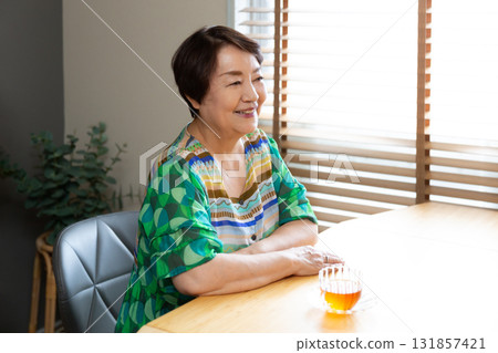 Senior women chatting with relaxed expressions, upper body Senior women chatting with relaxed expressions, upper body 131857421