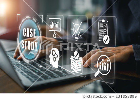 Hands typing on a laptop with digital icons representing a case study concept in business analysis and strategy. Hands typing on a laptop with digital icons representing a case study concept in business analysis and strategy. 131858899