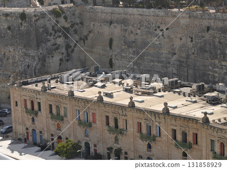 View of old building with windows, balconies in city. Republic of Malta, the picturesque city Valetta, Malta. View of old building with windows, balconies in city. Republic of Malta, the picturesque city Valetta, Malta. 131858929