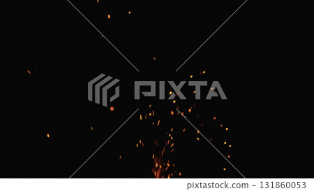 sparks and embers from campfire flying over black background 131860053