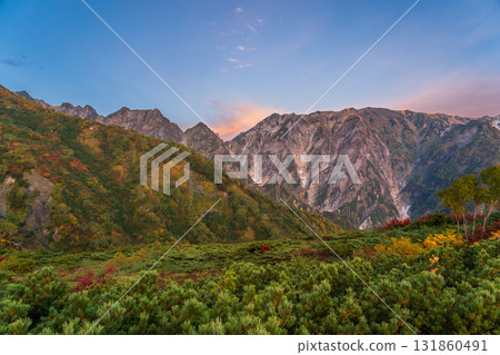 Early morning hike through autumn leaves at Happoyama and the sunrise in the Northern Alps 131860491