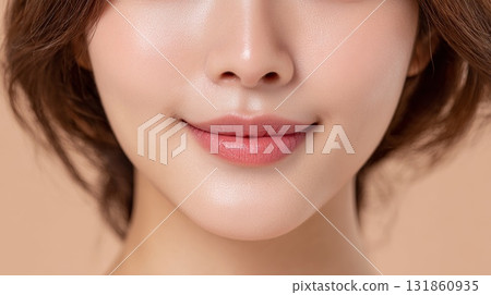 Close up of young Korean woman's chin showing multiple whiteheads and natural skin texture under soft neutral background 131860935