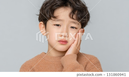 Close Up Portrait Of A Young Korean Boy Touching His Cheek In Pain Close Up Portrait Of A Young Korean Boy Touching His Cheek In Pain 131860941