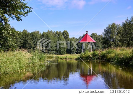 Tranquil Waterfront Gazebo on Sunny Day 131861042