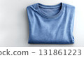 Soft blue cotton t shirt neatly folded flat on clean white surface 131861223