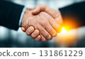 Two Business Professionals Shaking Hands in a Bright Modern Office Celebrating Secure Financial Agreement Completion and Trust 131861229