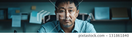Professional middle-aged Asian male telephone operator delivering exceptional client service in an office environment 131861840