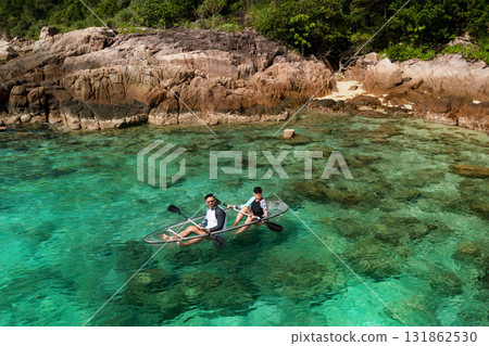 Two tourists are kayaking on a turquoise sea. A kayak adventure for two in crystal clear waters. Redang. Malaysia 131862530