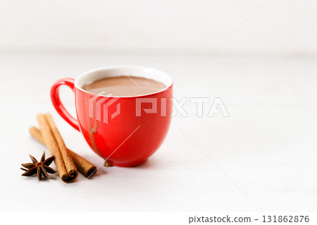 Hot chocolate in red cup on white wooden table background. 131862876