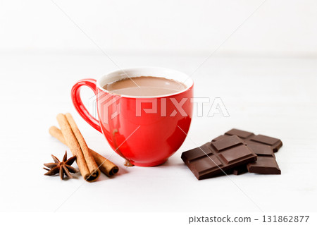 Hot chocolate in red cup on white wooden table background. Hot chocolate in red cup on white wooden table background. 131862877