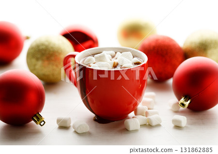Hot chocolate in red cup on white wooden table background. 131862885