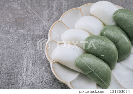 jeolpyeon, korean style Patterned Rice Cake, Short grain rice powder sieved and pressed into a rice cake mold. Unlike other rice cakes made with non-glutinous rice, jeolpyeon is quite chewy and often  131863054