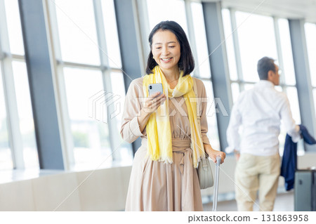 Business woman operating a smartphone Business woman operating a smartphone 131863958
