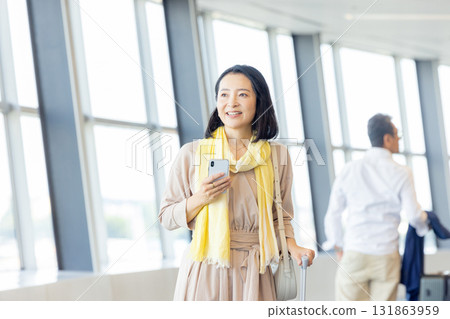 Business woman operating a smartphone Business woman operating a smartphone 131863959