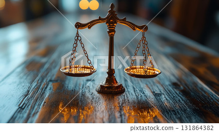 Vintage brass balance scale on wooden table with dramatic lighting, symbol of justice and fairness. Concept of law, equity and moral decisions Vintage brass balance scale on wooden table with dramatic lighting, symbol of justice and fairness. Concept of law, equity and moral decisions 131864382