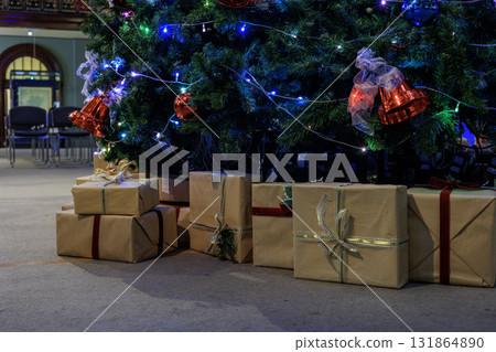 A pile of presents at the foot of the Christmas tree 131864890