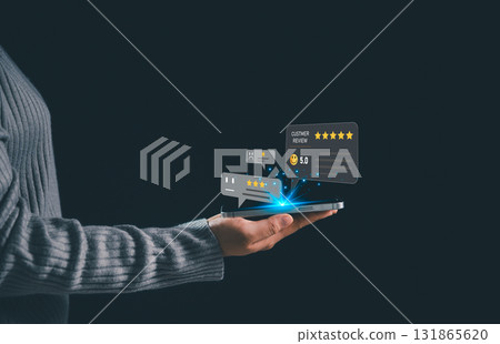 Businesswoman holding smartphone with floating customer review icons and star ratings, concept of online feedback, digital marketing, reputation management, customer satisfaction. satisfaction 131865620