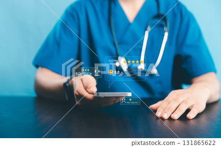 Doctor using smartphone with floating customer review icons and five-star rating, concept of healthcare feedback, patient satisfaction, digital medical service and hospital reputation management. 131865622