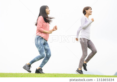 Two women running in the park 131865834