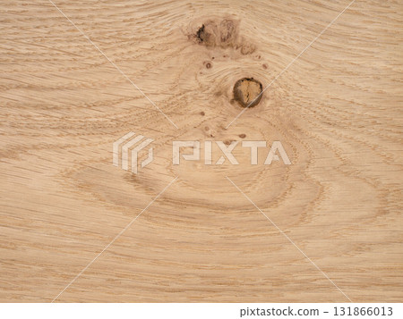 Rustic European oak veneer with a distinct knot and swirling grain patterns 131866013