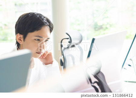 Man using a computer Man using a computer 131866412