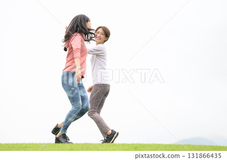 Two women high-fiving while running Two women high-fiving while running 131866435