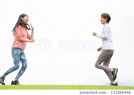 Two women high-fiving while running 131866446