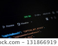Abstract view of a dark computer screen interface showing a glowing 200 OK status, alongside programming code and data visualization options, reflecting successful digital operations and web 131866919