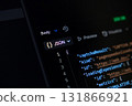 JSON programming code visible on a dark computer screen, illustrating data exchange protocols fundamental for modern web development and backend applications 131866921