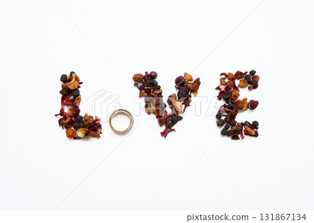 The word "love" written by the bride, on wedding day with the help of tea and wedding rings. The word "love" written by the bride, on wedding day with the help of tea and wedding rings. 131867134