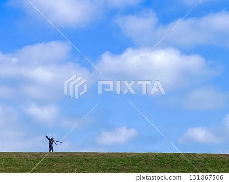 A person carrying a camera and tripod passes by on the bank 131867506