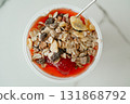 Healthy breakfast bowl with yogurt, strawberry jam and crunchy muesli on white background. Close-up of nutritious food 131868792