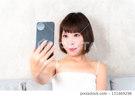 Young woman taking a selfie 131869296