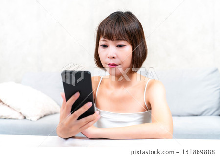A young woman touching a smartphone 131869888
