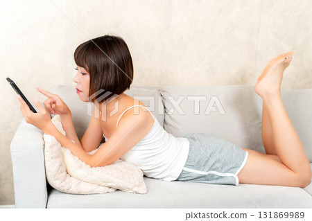 A young woman touching a smartphone 131869989