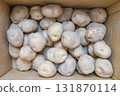 A lot of potatoes in a cardboard box 131870114